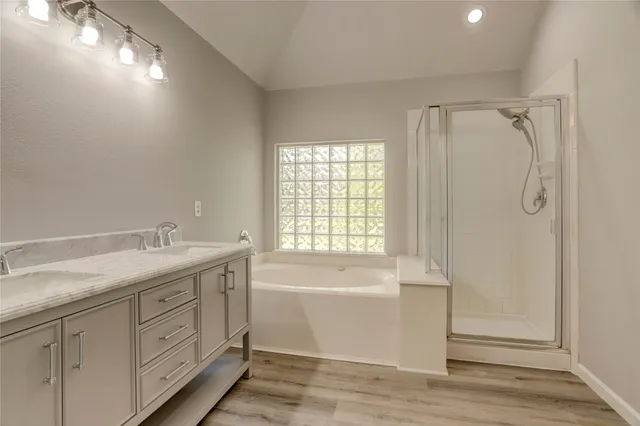 a bedroom with bed and a potted plant