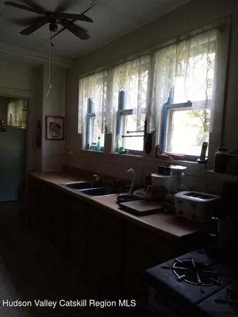 a stove top oven sitting inside of a kitchen