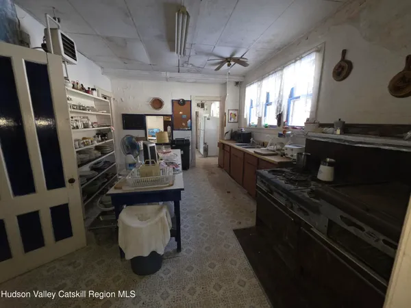a living room with furniture a window and gym equipment