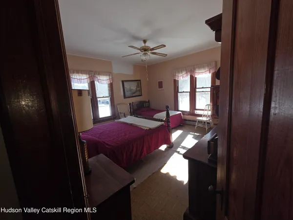 a view of a hallway with furniture and window