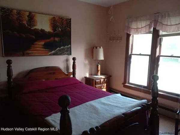 a bedroom with bed and window