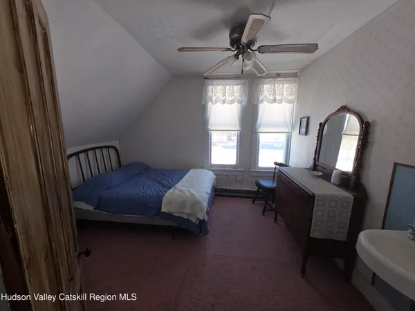 a bedroom with furniture and a window