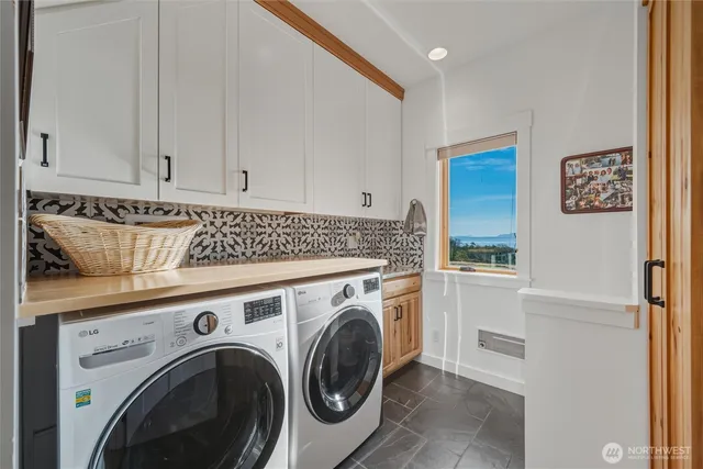 a view of washer and dryer with kitchen in the background