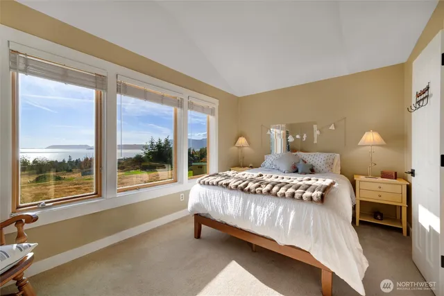 a bedroom with a bed and a large window