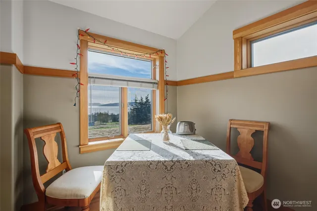 a bedroom with a bed and a dresser next to a window
