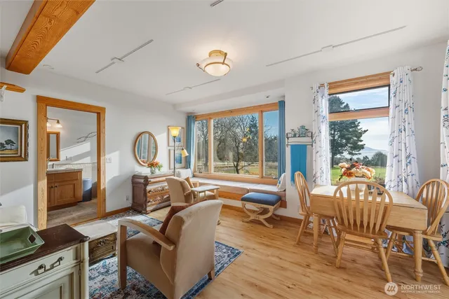 a living room with furniture a flat screen tv and a large window