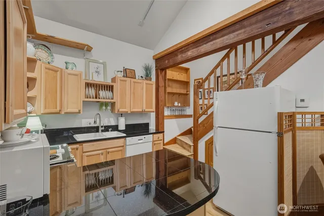 a kitchen with stainless steel appliances a refrigerator and a stove top oven