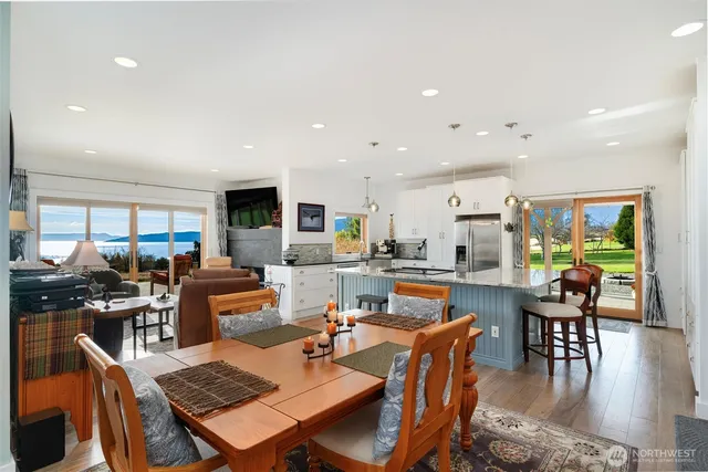 a dining room with furniture a rug and a kitchen view