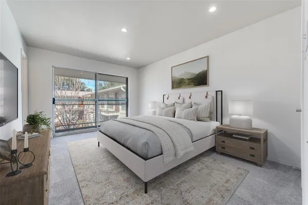 a spacious bedroom with a bed and a window