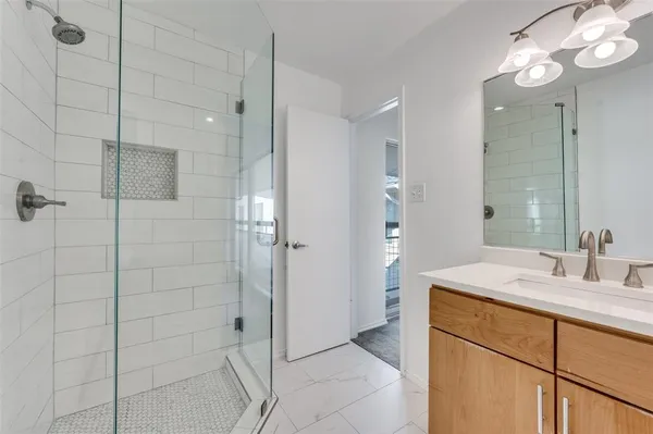 a bathroom with a sink a mirror and shower