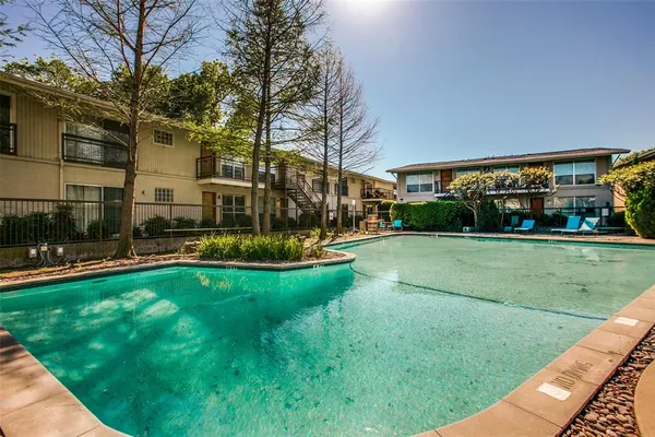 a view of yard with swimming pool and green space