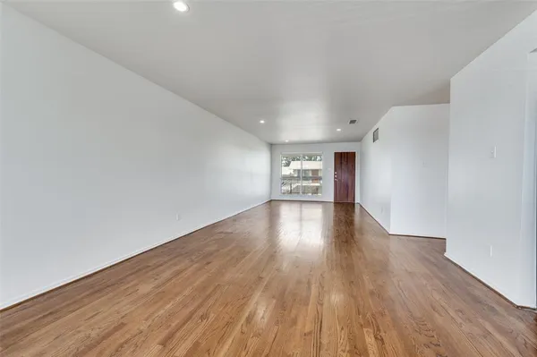 a view of wooden floor and windows in an empty room