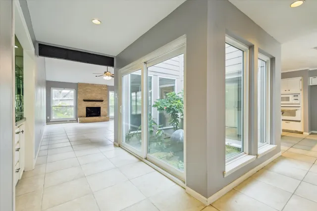 a view of an empty room with a fireplace and a window