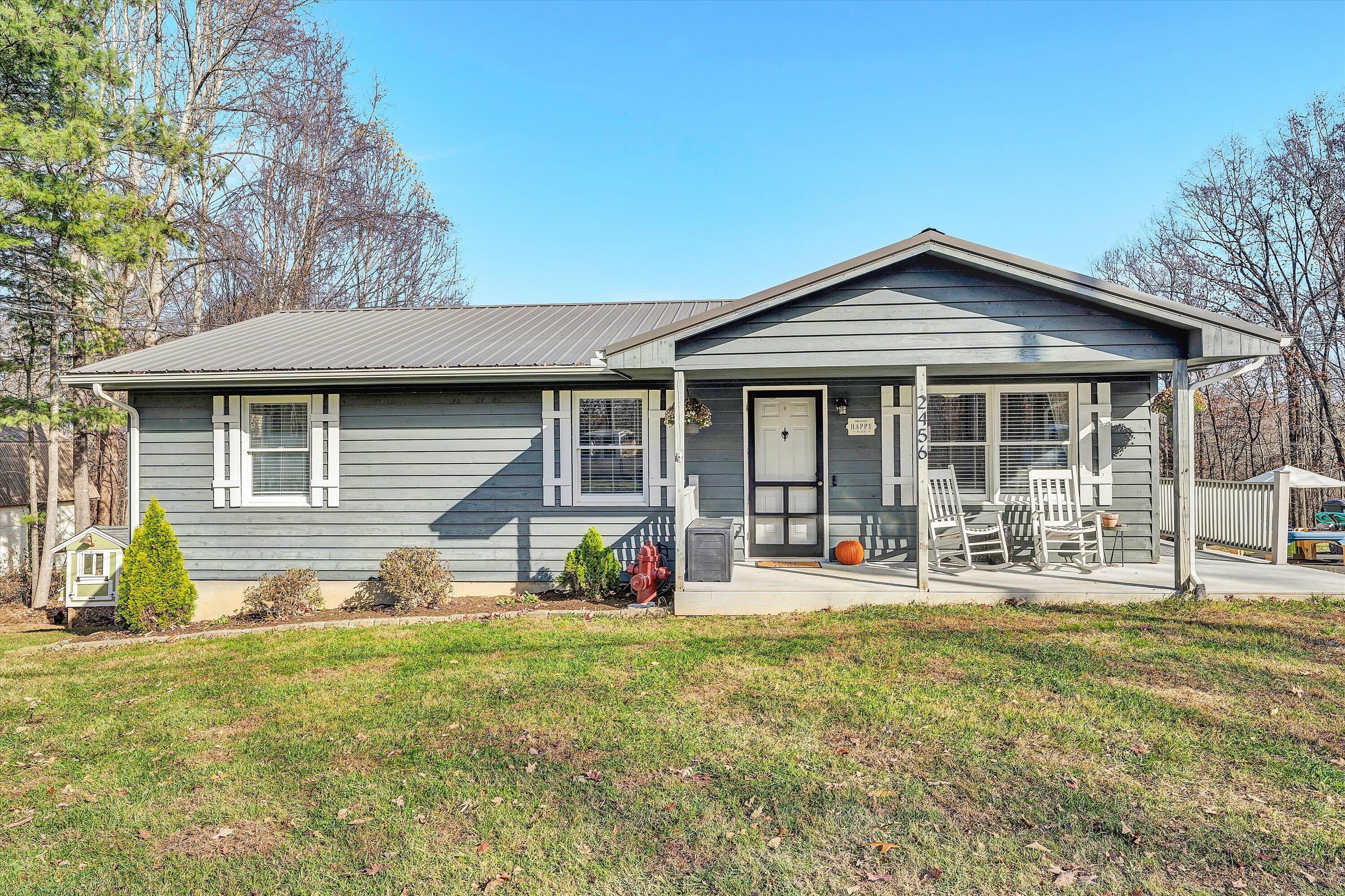 a front view of a house with a yard outdoor seating and garage