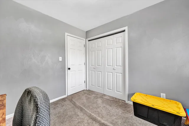 a bedroom with a bed and a couch