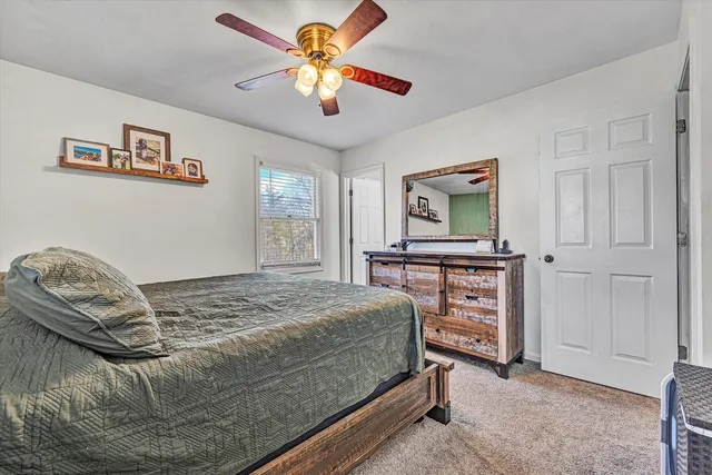 a bathroom with a sink vanity mirror and toilet