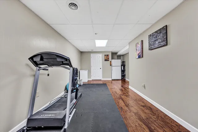 a living room with furniture a flat screen tv and a couch