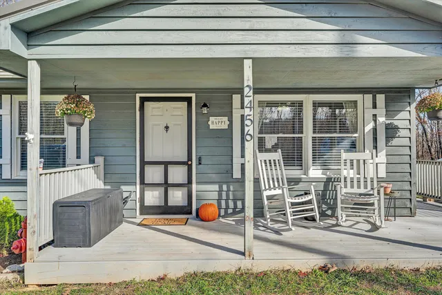 a backyard of a house with barbeque oven table and chairs