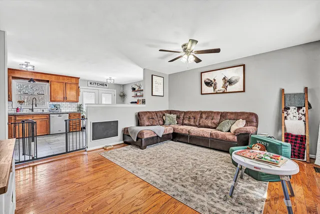 a living room with furniture and a kitchen view