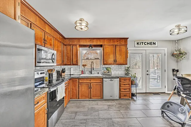 a kitchen with stainless steel appliances a sink and cabinets