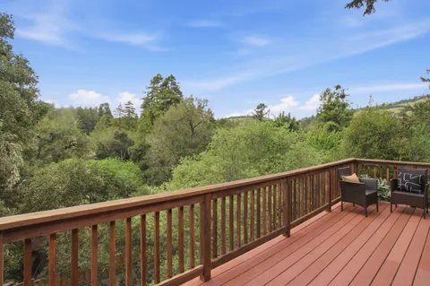 a balcony with wooden floor and fence