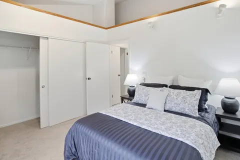 a bedroom with a bed and a night stand