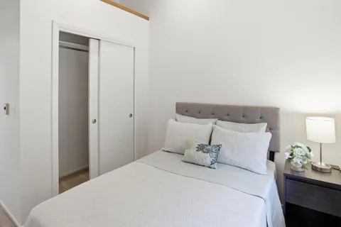 a bedroom with a bed and a lamp