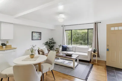 a kitchen with a stove a sink and a white cabinets