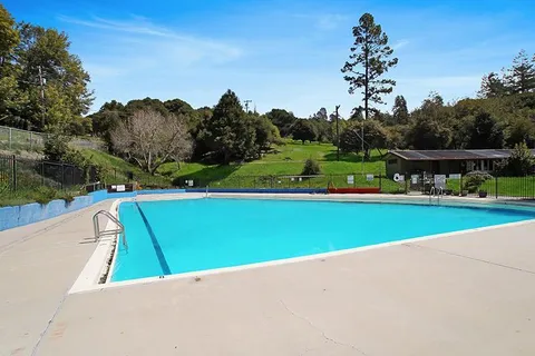 a view of a park with swings and slides