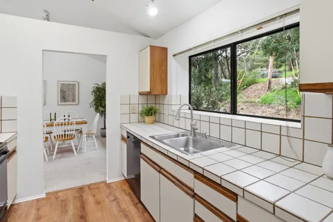 a kitchen that has a sink and a stove