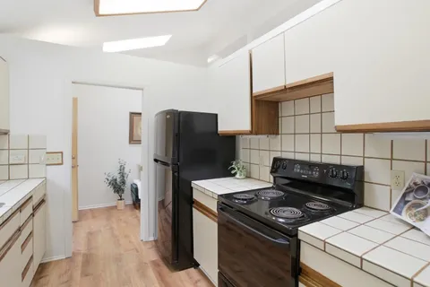 a kitchen with a stove and a refrigerator