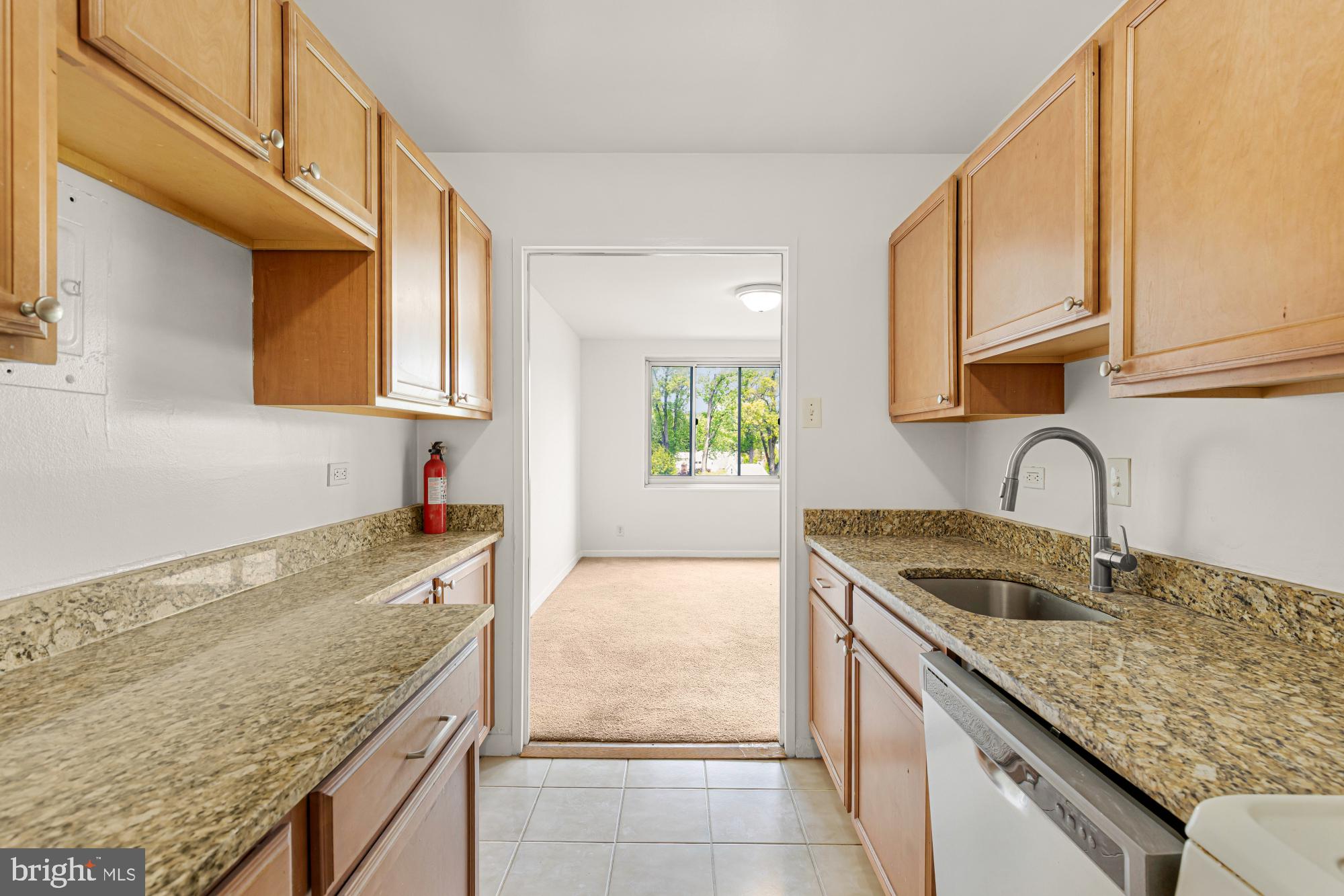1900 Lyttonsville Road, Unit 818 Silver Spring, MD 20910 - Photo 11 of 23 a kitchen with granite countertop a sink a stove and cabinets