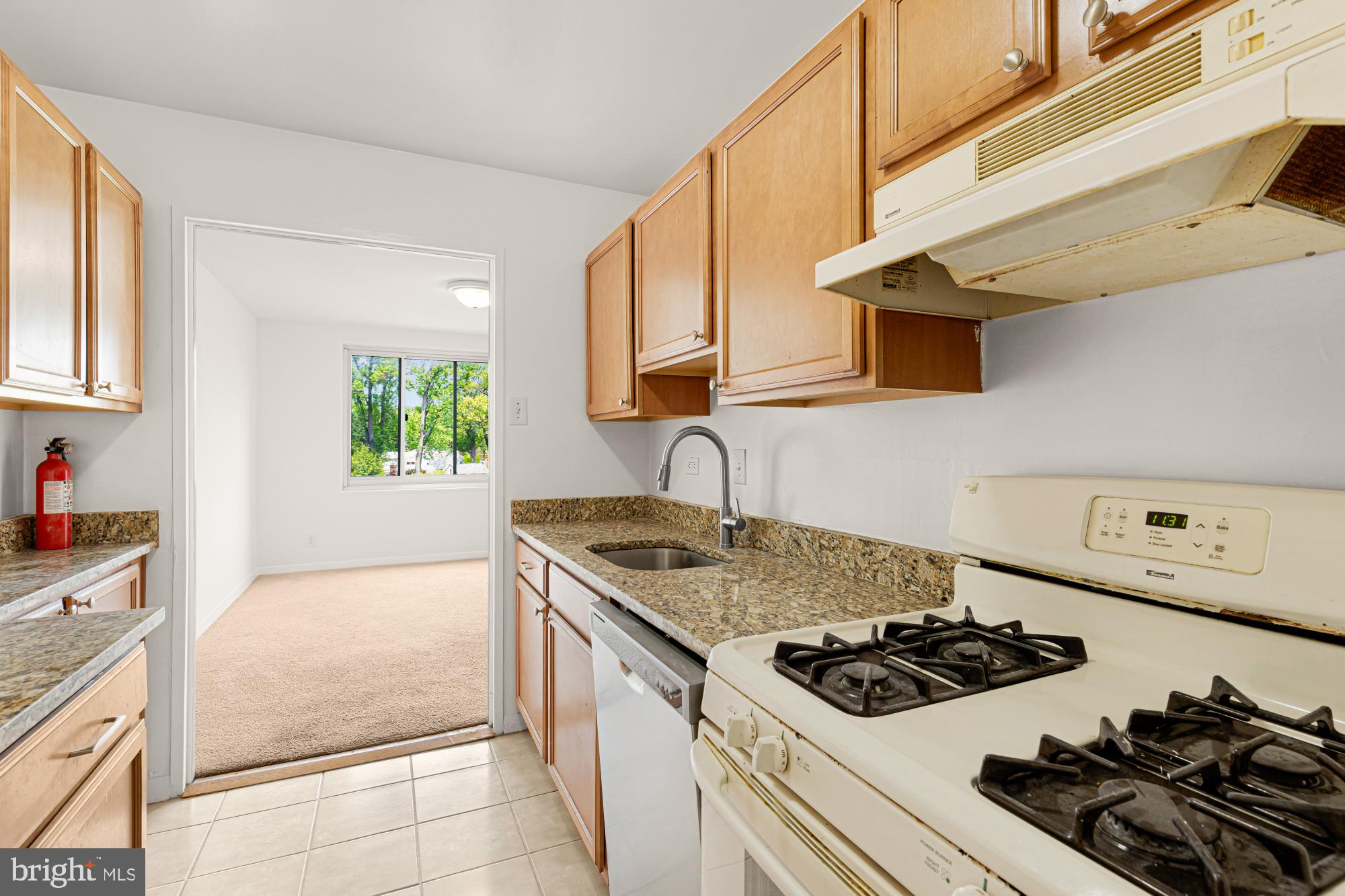 1900 Lyttonsville Road, Unit 818 Silver Spring, MD 20910 - Photo 12 of 23 a kitchen with a stove and a sink