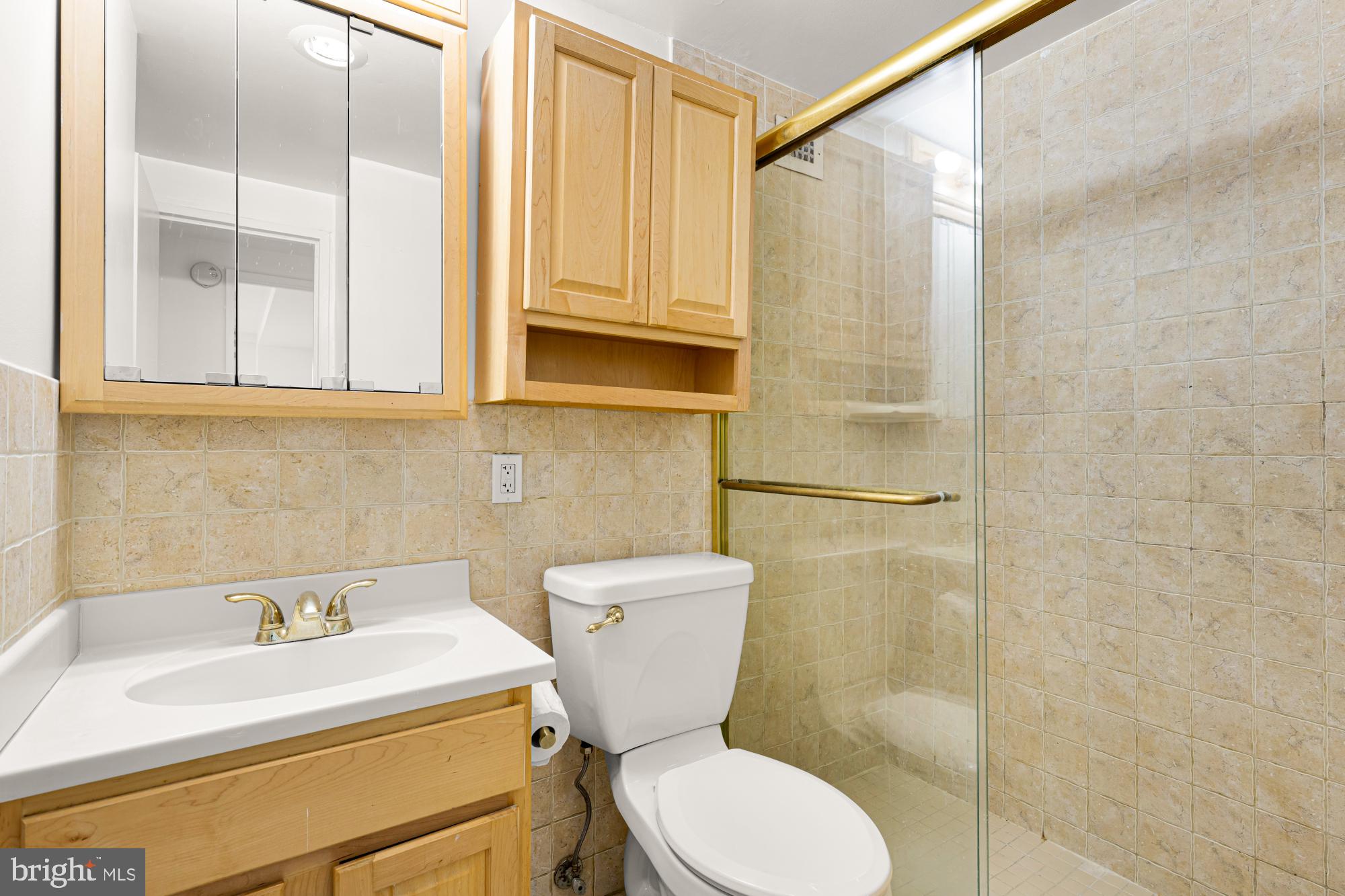 1900 Lyttonsville Road, Unit 818 Silver Spring, MD 20910 - Photo 13 of 23 a bathroom with a sink a toilet and shower