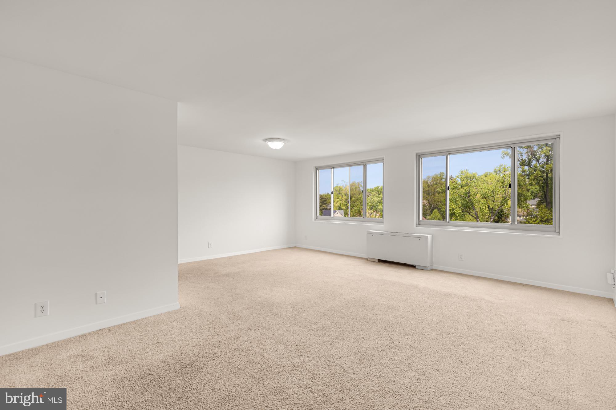 1900 Lyttonsville Road, Unit 818 Silver Spring, MD 20910 - Photo 6 of 23 an empty room with windows and garden