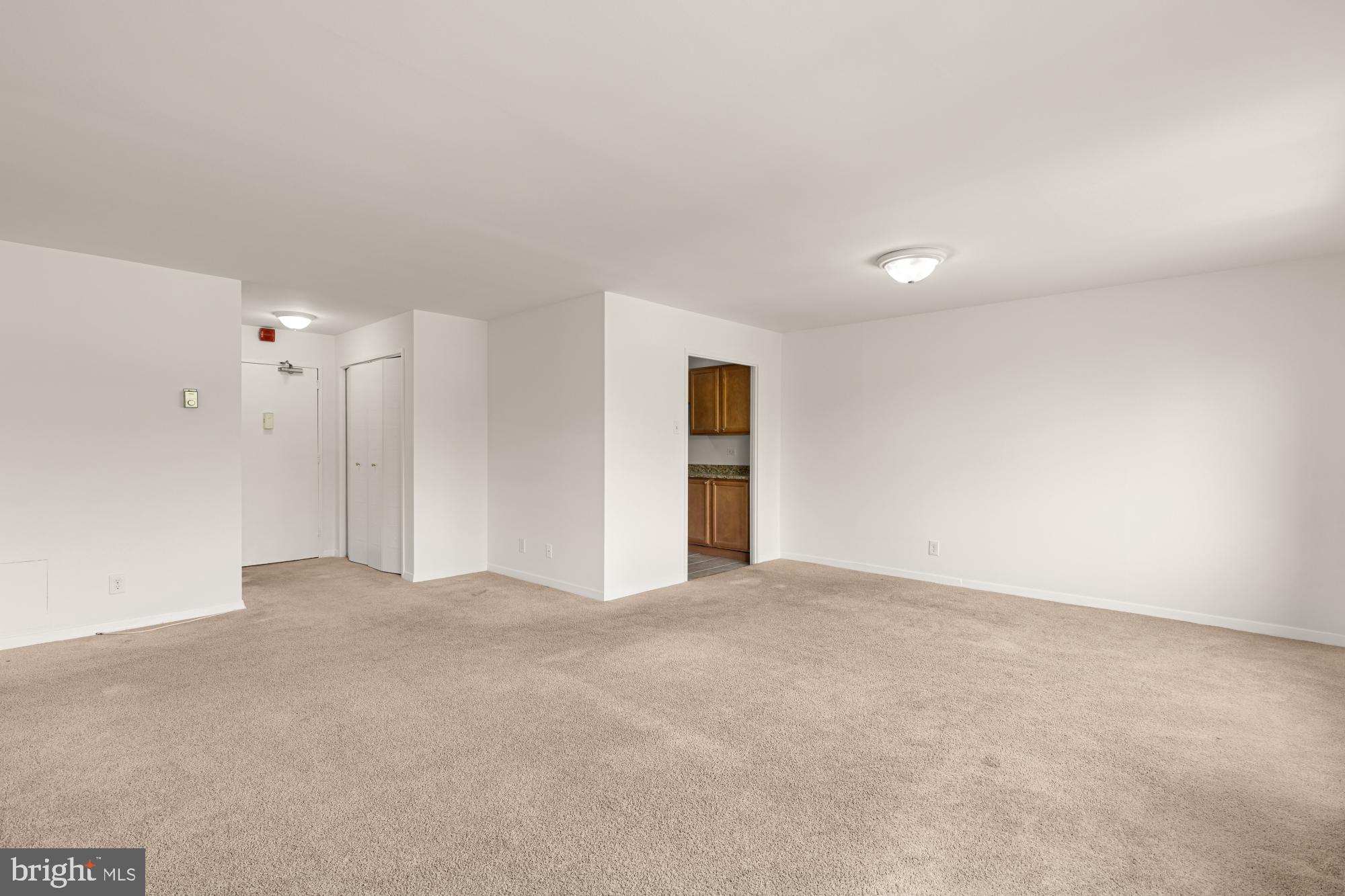 1900 Lyttonsville Road, Unit 818 Silver Spring, MD 20910 - Photo 7 of 23 a view of an empty room with a kitchen