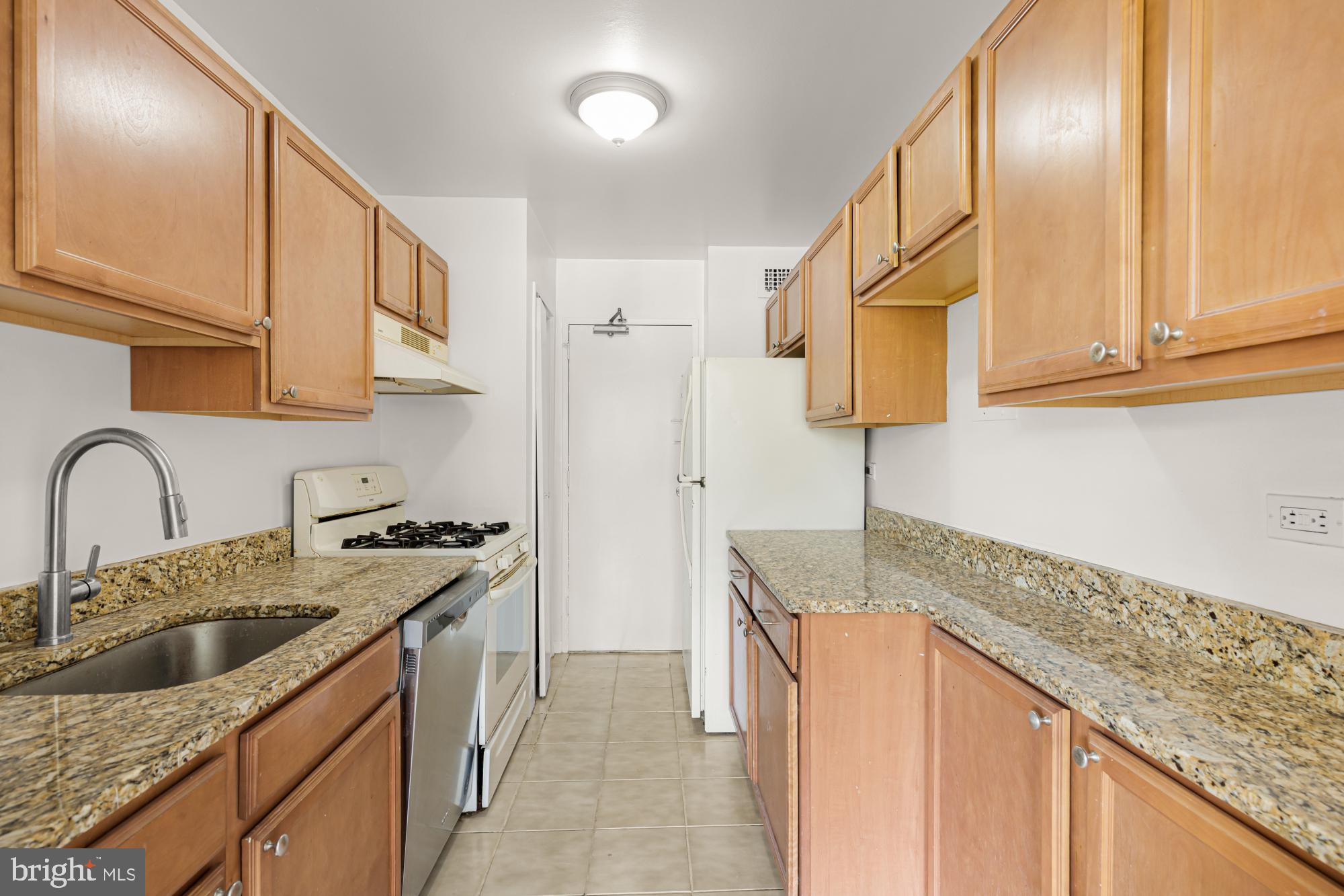 1900 Lyttonsville Road, Unit 818 Silver Spring, MD 20910 - Photo 9 of 23 a kitchen with stainless steel appliances granite countertop a sink stove and cabinets