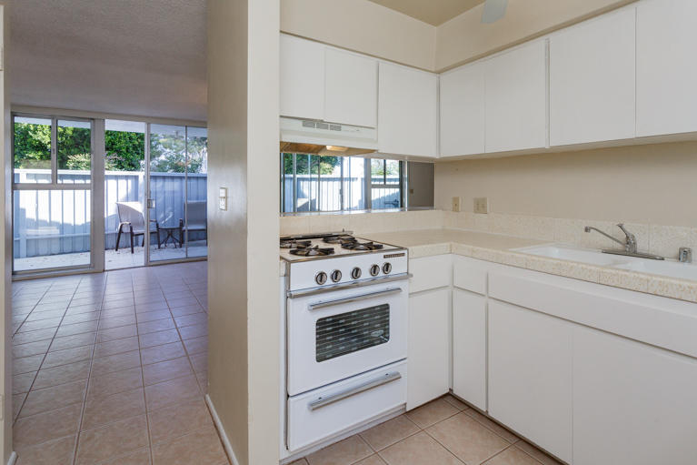 42308 Dunes View Road, Unit 20 Rancho Mirage, CA 92270 - Photo 11 of 30 a kitchen with a stove a sink and a refrigerator