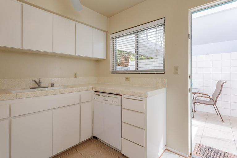 42308 Dunes View Road, Unit 20 Rancho Mirage, CA 92270 - Photo 13 of 30 a utility room with cabinets washer and dryer