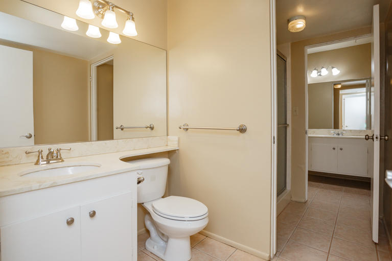 42308 Dunes View Road, Unit 20 Rancho Mirage, CA 92270 - Photo 23 of 30 a bathroom with a toilet a sink a mirror and a shower