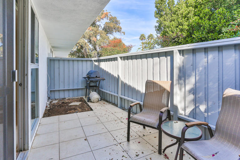 42308 Dunes View Road, Unit 20 Rancho Mirage, CA 92270 - Photo 24 of 30 a view of balcony with chairs and wooden fence