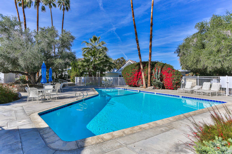 42308 Dunes View Road, Unit 20 Rancho Mirage, CA 92270 - Photo 28 of 30 a view of a swimming pool with a lounge chairs