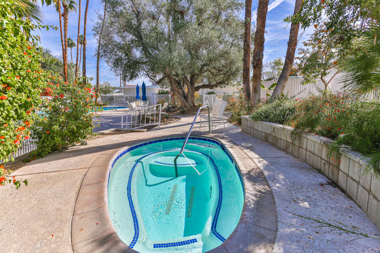 42308 Dunes View Road, Unit 20 Rancho Mirage, CA 92270 - Photo 29 of 30 a view of a swimming pool with a patio