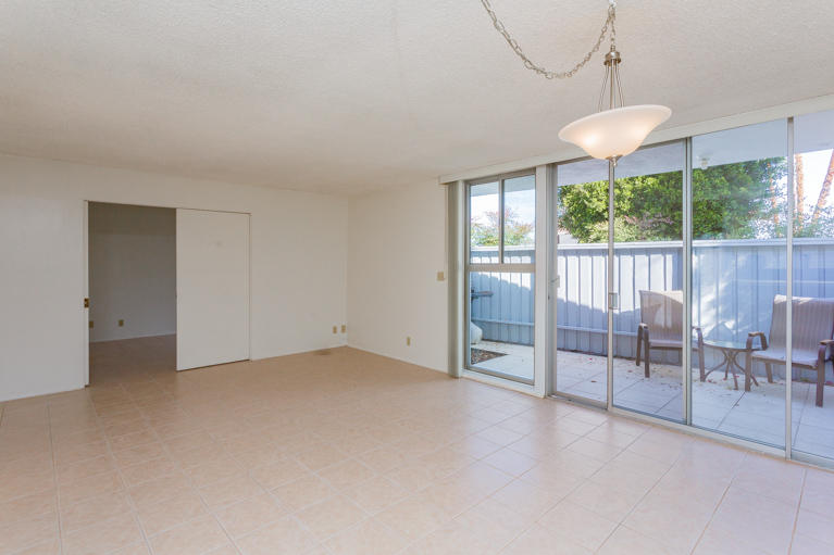42308 Dunes View Road, Unit 20 Rancho Mirage, CA 92270 - Photo 7 of 30 an empty room with windows and outdoor view