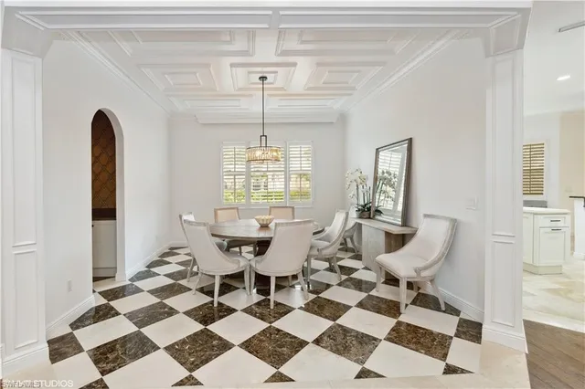 a view of a dining room with a table and chairs