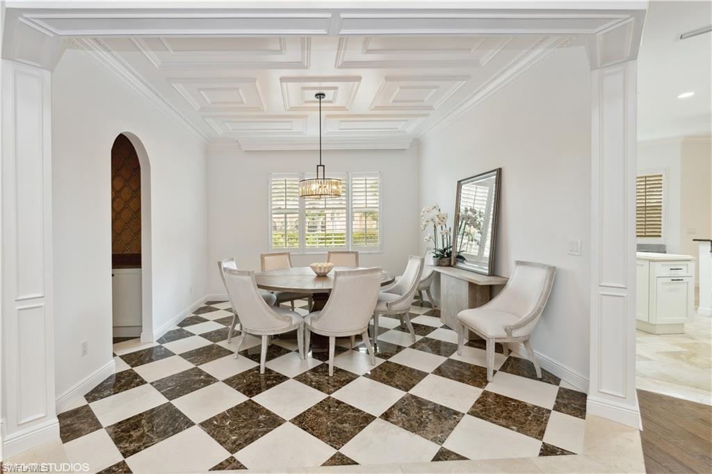 6501 Crown Colony Place, Unit 4201 Naples, FL 34108 - Photo 15 of 35 a view of a dining room with a table and chairs