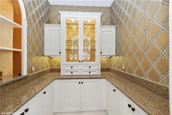 a bathroom with a granite countertop bathtub sink vanity and mirror