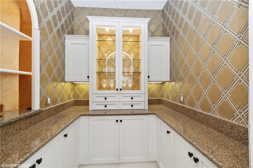 6501 Crown Colony Place, Unit 4201 Naples, FL 34108 - Photo 17 of 35 a bathroom with a granite countertop bathtub sink vanity and mirror
