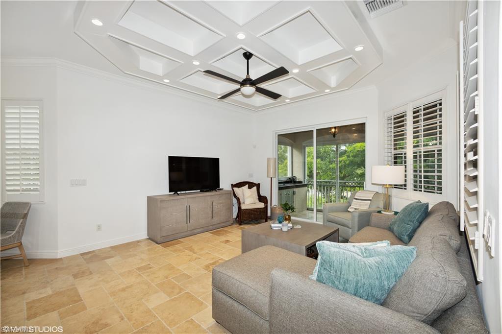 6501 Crown Colony Place, Unit 4201 Naples, FL 34108 - Photo 18 of 35 a living room with furniture and a flat screen tv
