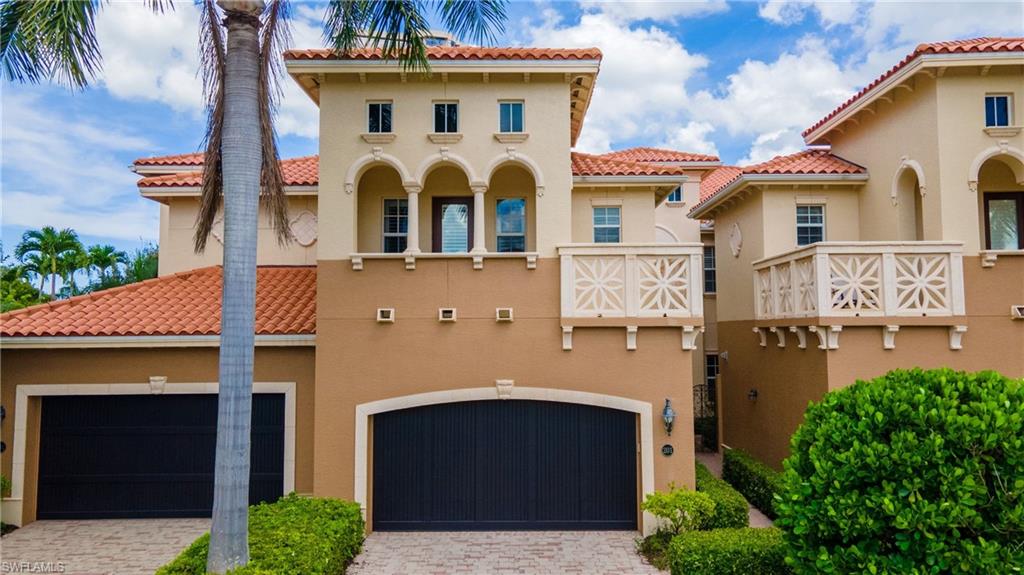 6501 Crown Colony Place, Unit 4201 Naples, FL 34108 - Photo 2 of 35 a front view of a house with a yard